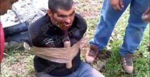Cartel members with the CJNG strap a stick of dynamite to one of their rivals in order to kill him. 