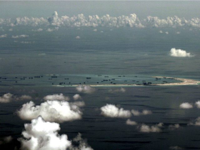 IN FLIGHT, IN FLIGHT : This aerial photograph taken from a military aircraft shows alleged on-going reclamation by China on Mischief Reef in the Spratly group of islands in the South China Sea, west of Palawan, on May 11, 2015. The Spratlys are considered a potential Asian flashpoint, and claimant …