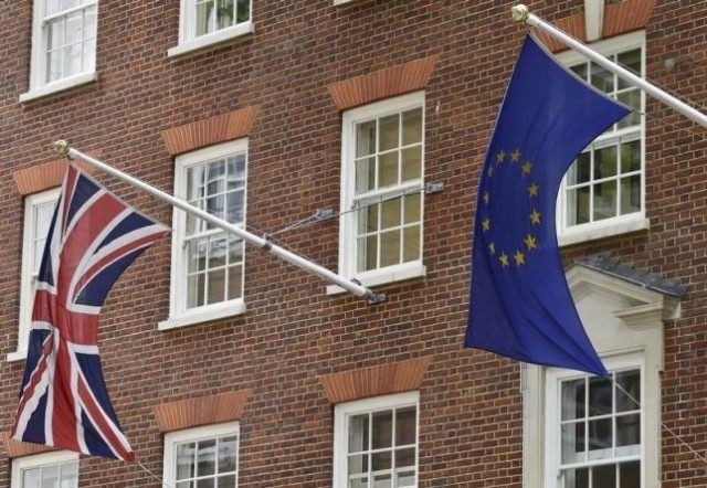 The British Union flag and European Union flag are seen hanging outside Europe House in ce