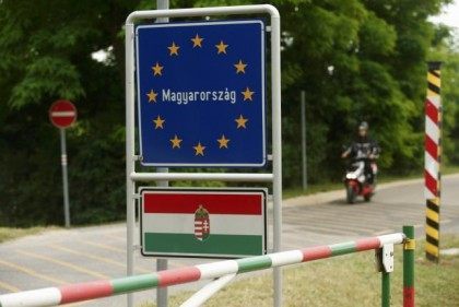 A motorcyclist passes the border between Austria und Hungary near St. Margarethen
