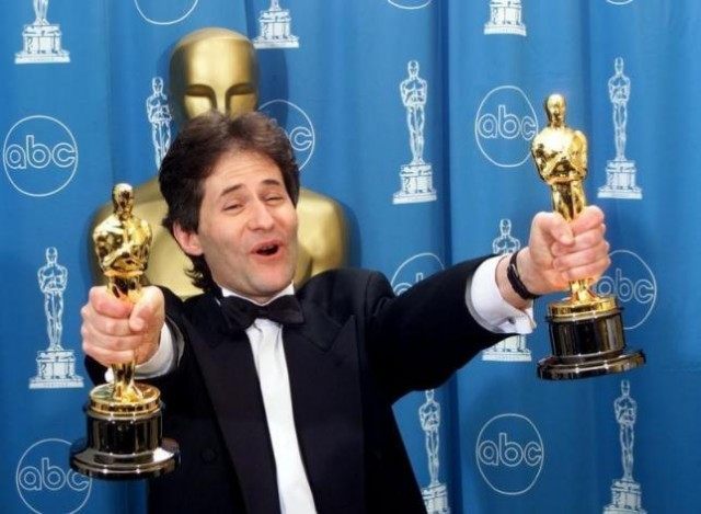 James Horner holds up two Oscars after winning for Best Original Song and Original Dramati
