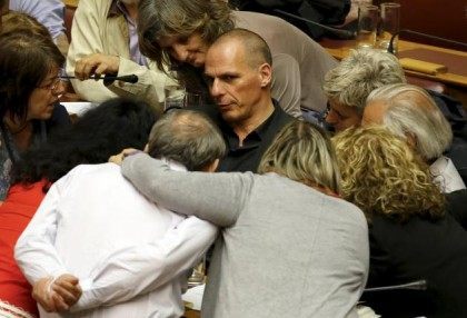 Greek Finance Minister Varoufakis is surrounded by lawmakers during a parliamentary sessio