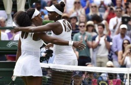 Serena Williams of the U.S.A. embraces Venus Williams of the U.S.A. after winning their match at the Wimbledon Tennis Championships in London