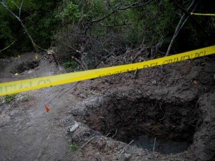 FILE - In this Oct. 6, 2014 file photo, clandestine graves are taped off after 28 bodies were found in them near Iguala, Mexico. Mass graves are regularly found around the country _ 11 bodies in August in Michoacan state, 19 others in Iguala just last May. (AP Photo/Eduardo Verdugo)
