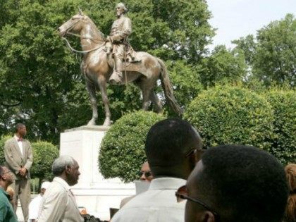 Protesters attend a rally protesting against the name of Nathan Bedford Forrest Park in front of a statue bearing his likeness August 13, 2005 in Memphis, Tennessee. Nathan Bedford Forrest was a Civil War General who led troops against the north. Forrest was originally buried in Elmwood Cemetery in Memphis. …