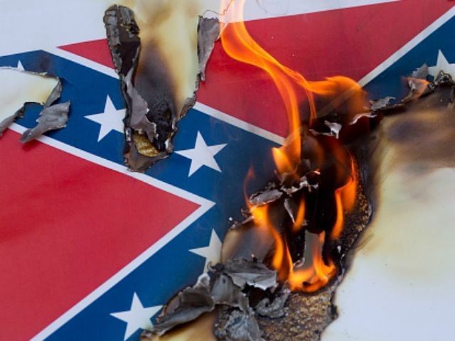 Protesters burn a paper Confederate flag during a rally on June 23, 2015 in Los Angeles, C