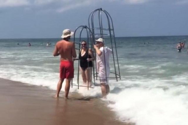 Couple-swim-in-homemade-shark-cages-at-North-Carolina-beach-in-viral-video