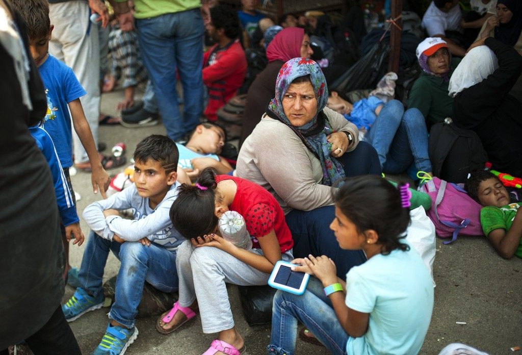 Migrants wait for a train to Serbia in the town of Gevgelija (ROBERT ATANASOVSKI/AFP/Getty Images)
