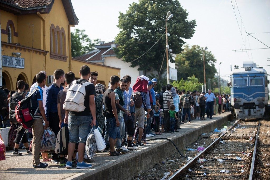 Migrants prepare to enter a train to Serbia in the town of Gevgelija, on the Macedonian-Greek border, on July 9, 2015 (ROBERT ATANASOVSKI/AFP/Getty Images)