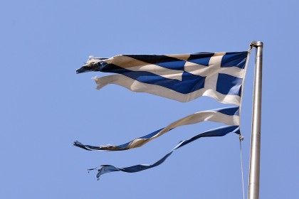 A ripped Greek national flag flutters in central Athens (LOUISA GOULIAMAKI/AFP/Getty Images)