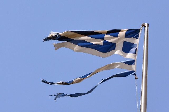 A ripped Greek national flag flutters in central Athens (LOUISA GOULIAMAKI/AFP/Getty Image