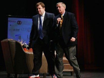 Republican presidential hopeful Senator Lindsey Graham (R) of South Carolina walks across the stage with Frank Luntz at The Family Leadership Summit at Stephens Auditorium on July 18, 2015 in Ames, Iowa. According to the organizers the purpose of The Family Leadership Summit is to inspire, motivate, and educate conservatives.