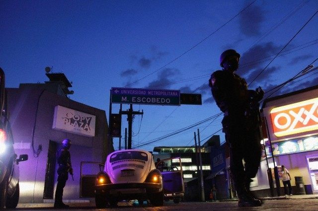 Police patrol near the main office of the newspaper El Norte in Monterrey