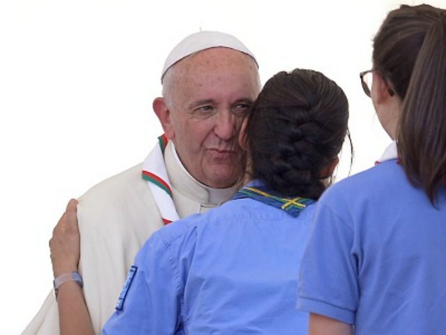 A girl scout kisses Pope Francis at the end of an audience to the Italian Catholics Scouts