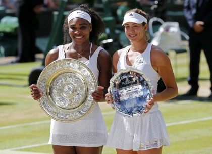 Winner Serena Williams of the U.S.A and runner up Garbine Muguruza of Spain show off their trophies after their Women's Final Match at the Wimbledon Tennis Championships in London