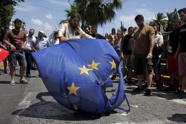 Anti-EU protesters burn a European Union flag in front of the European Parliament represen
