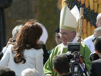 Pope Francis shakes hands with Argentinian President Cristina Fernandez de Kirchner after his mass at Nu Guazu field in the outskirts of Asuncion, Paraguay on July 12, 2015. The Pope finishes Sunday his Latin American tour. AFP PHOTO /JUAN MABROMATA (Photo credit should read J