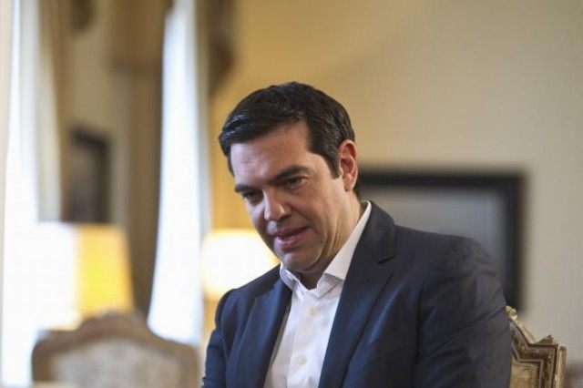 Greek Prime Minister Alexis Tsipras looks on as he attends a meal at the Presidential Pala