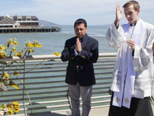 Father Cameron Faller, right, and Julio Escobar, of Restorative Justice Ministry, conduct a vigil for Kathryn Steinle, Monday, July 6, 2015, on Pier 14 in San Francisco.