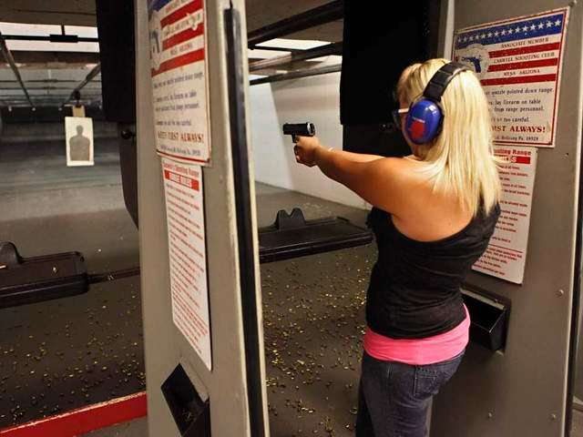 Sarah Bard, of Gilbert, shoots at Caswells Shooting Range, Tuesday, April 6, 2010 in Mesa, Ariz. in preparation for her upcoming concealed weapons test. Gov. Jan Brewer has signed into law two bills supported by gun-rights activists. One of the bills signed Monday would broaden the state's current restrictions on …