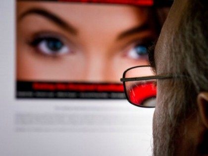 A man looks at a dating site on his computer in Washington,DC on February 10, 2014. One 29-year-old woman says it helped her take revenge on her unfaithful husband. A 45-year-old married man says it has helped prevent the break-up of his family. For millions, adultery via the Internet has …