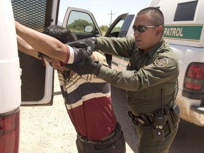 CBP Border Patrol agent does a pat down of a Mexican being returned to Mexico.