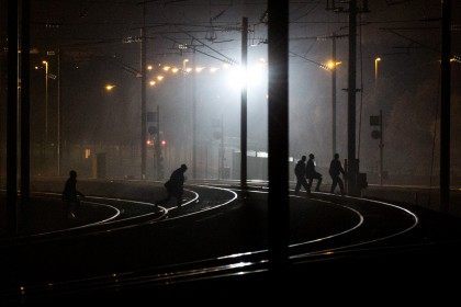 People walk across train tracks near the Eurotunnel terminal (Rob Stothard/Getty Images)