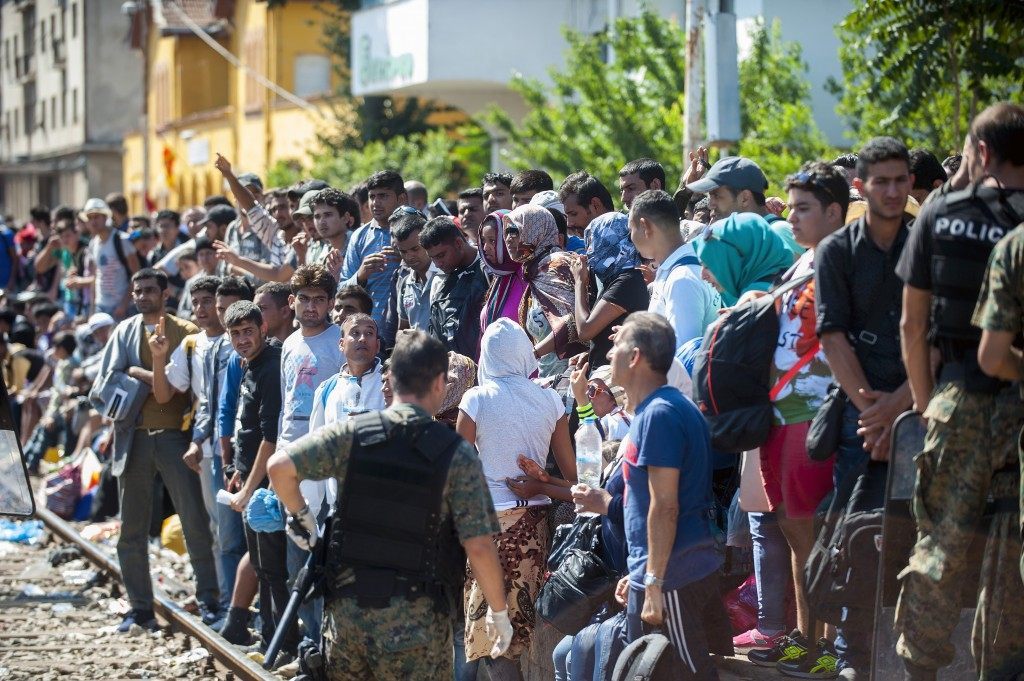 Migrants wait on a platform to get a permission from police to board a train to Serbia (ROBERT ATANASOVSKI/AFP/Getty Images)