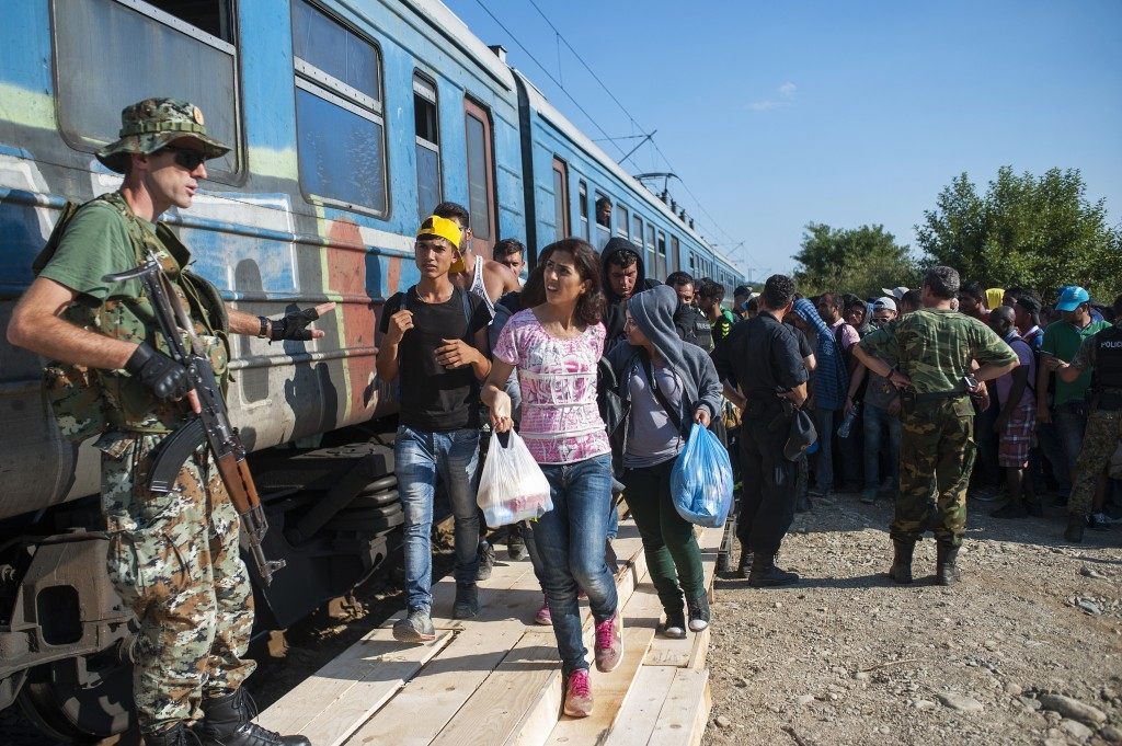 Migrants board a train to Serbia in the new reception center near the town of Gevgelija. (ROBERT ATANASOVSKI/AFP/Getty Images)