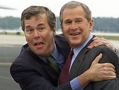 US President George W. Bush (R) is greeted by his