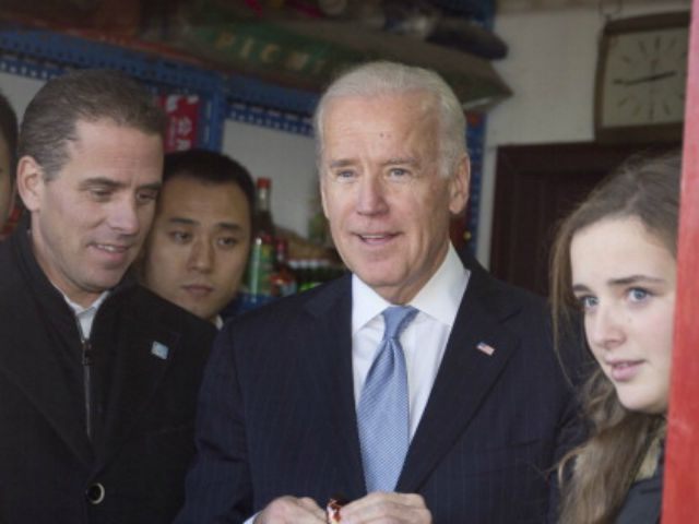 US Vice President Joe Biden (C) buys an ice-cream at a shop as he tours a Hutong alley with his granddaughter Finnegan Biden (R) and son Hunter Biden (L) in Beijing on December 5, 2013. Biden said on December 5 China's air zone had caused 'significant apprehension' and Beijing needed …