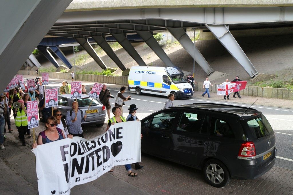 Pro-immigrant demonstrators march under a bridge