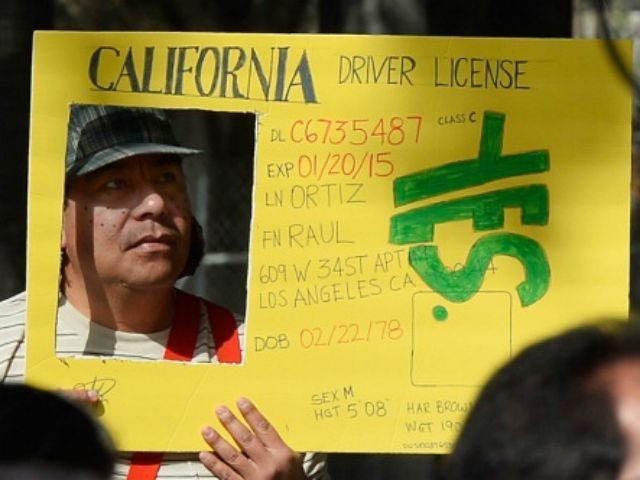 Raul Ortega holds a sign as he celebrates after California Governor Jerry Brown signed bil