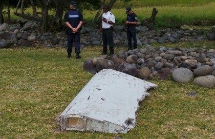 French gendarmes and police stand near a large piece of plane debris which was found on th