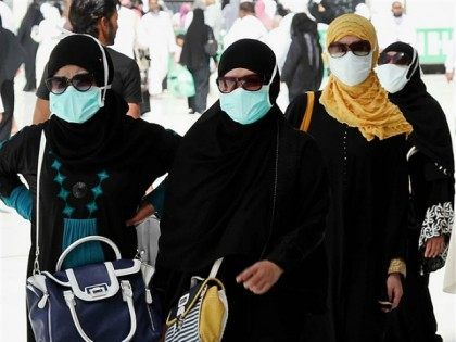 SAUDI ARABIA, MECCA : TO GO WITH AFP STORY BY ABDEL HADI HABTOOR Muslim pilgrims wear nose and mouth masks on the way to Islam's holiest shrine, the Kaaba, in the Grand Mosque in the Muslim holy city of Mecca in Saudi Arabia on May 27, 2014. Muslims pilgrims from …