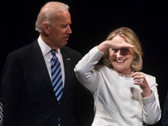 Hillary Clinton looks out at the audience with Vice President Joe Biden at the end of the