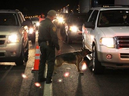 Caption:NOGALES, AZ - DECEMBER 07: A border patrol agent and Gitta, a drug-sniffing German