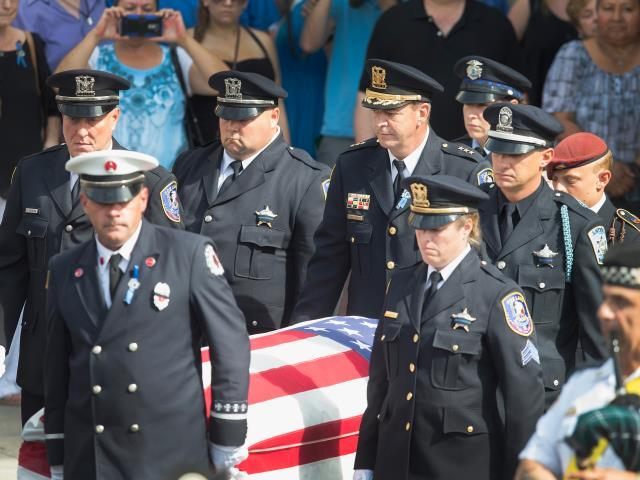 The casket bearing the body of Lt. Joe Gliniewicz is carried from the church by police officers, a fireman and an Army soldier. (Photo: Scott Olson/Getty Images)
