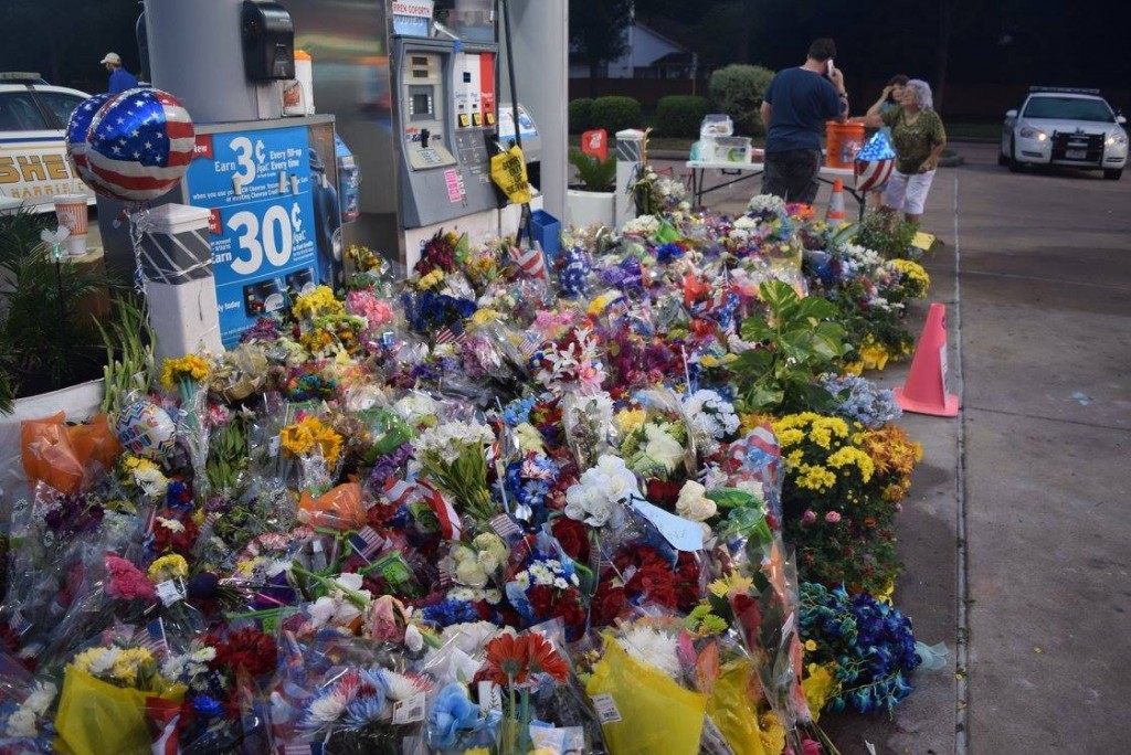 Tributes of flowers and donations continue to build at the Chevron station where Deputy Goforth was executed. (Photo: Breitbart Texas/Bob Price)