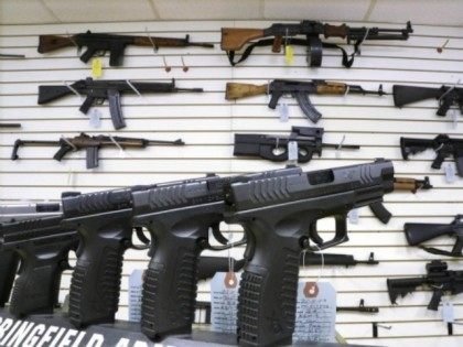 FILE - In this Jan. 16, 2013 file photo, assault weapons and handguns are seen for sale at