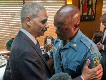 Attorney General Eric Holder (L) talks with Capt. Ron Johnson, right, of the Missouri State Highway Patrol at Drake's Place Restaurant,August 20, 2014 in Ferguson, Missouri. Holder is traveling to Ferguson, Mo., to oversea the federal government's investigation into the shooting of 18-year-old Michael Brown by a police officer on …