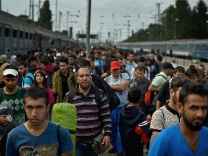 HEGYSHALOM, HUNGARY - SEPTEMBER 15: Hundreds of migrants arrive off a train from Roszke, at Hegyshalom railway station on the Austrian border after Hungarian authorities closed the open railway track crossing on September 15, 2015 in Hegyeshalom, Hungary.