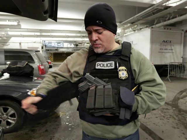In this March 2, 2015 photo, an Immigration and Customs Enforcement officer "tacs up&