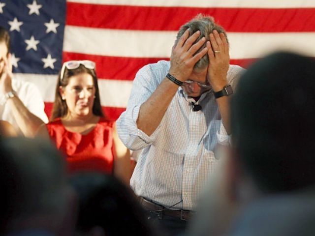 epublican presidential candidate and former Florida Governor Jeb Bush holds his head after