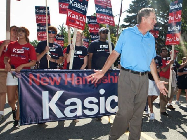Republican presidential candidate John Kasich marches in the annual Labor Day parade on Se