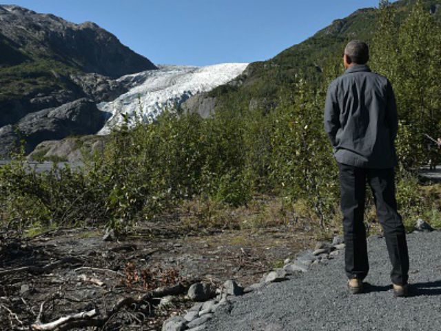 President Barack Obama looks at the pauses to admire the view while hiking near the Exit G