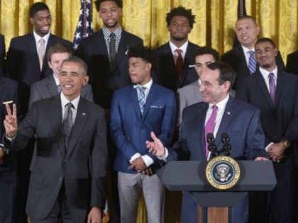President Barack Obama holds up two fingers to indicate the number of times that the Duke basketball team has been honored at the White House as head coach Mike Krzyzewski (R) speaks during an event in honor of the Duke Blue Devils Mens Basketball team and their 2015 NCAA Championship …