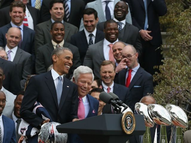 U.S. President Barack Obama (C) shares a laugh with owner Robert Kraft (R) during an event