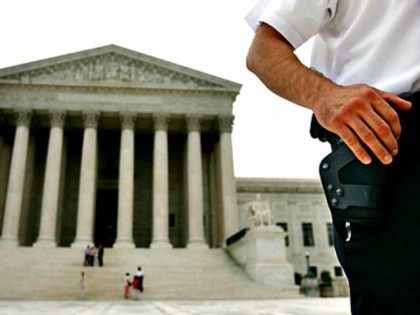 Policeman with Gun at Supreme Court Jacquelyn MartinAP Photo