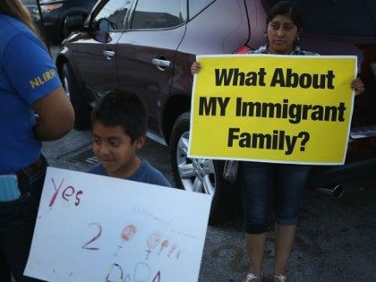 Kevin Valazquez,6, (L) and Irma Lopez Aguilar stand with others as they show their support